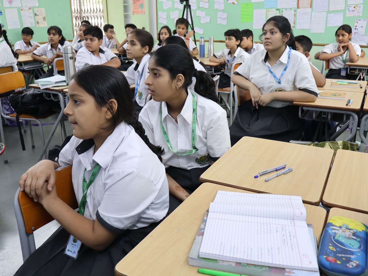 Students seated at desks listening attentively during the workshop