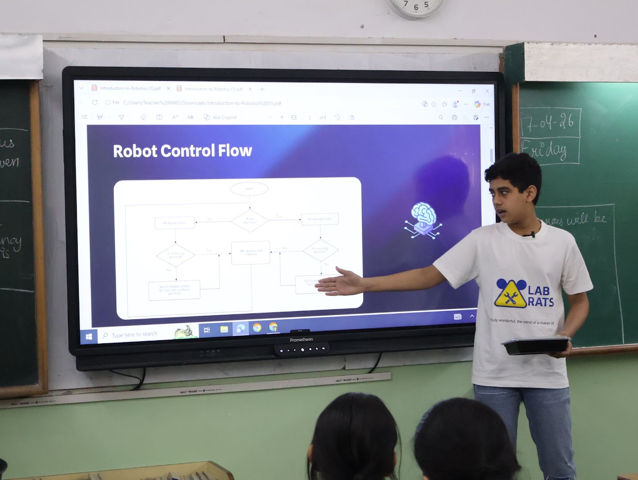 Prashast pointing at a screen showing a 