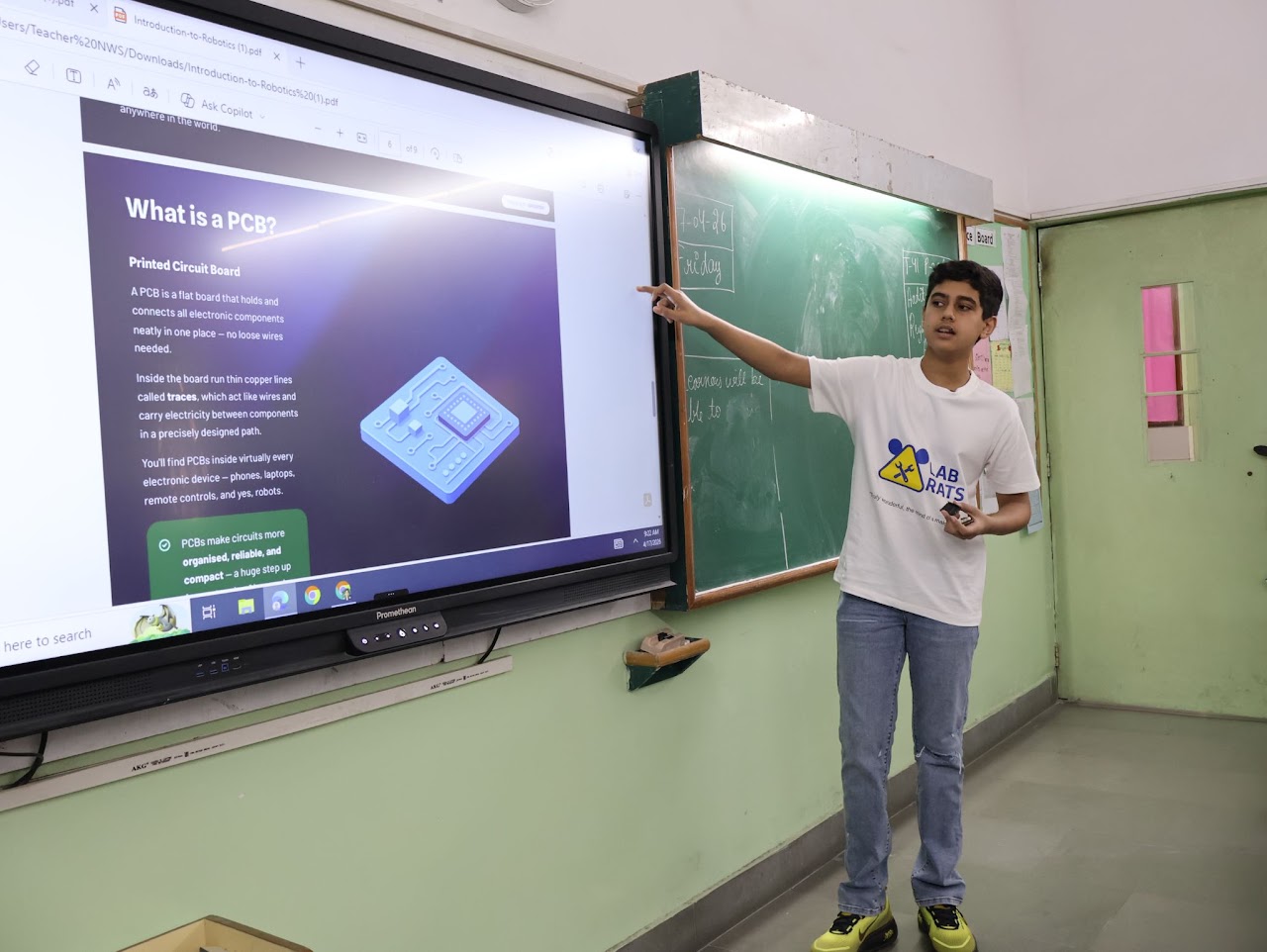 Prashast pointing at a screen explaining 